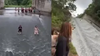 Вижте как жители използват преливника на язовир като водна пързалка Видео